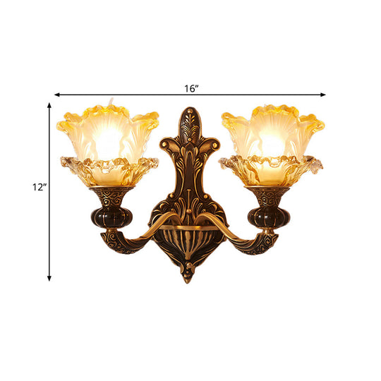 Rustic Half-Head Wall Lamp With Curvy Metallic Design And Flower Amber Glass Shade - Brass Finish