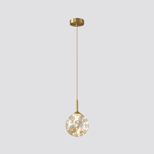 Sleek Brass Sphere Led Pendant Lamp For Modern Dining Rooms