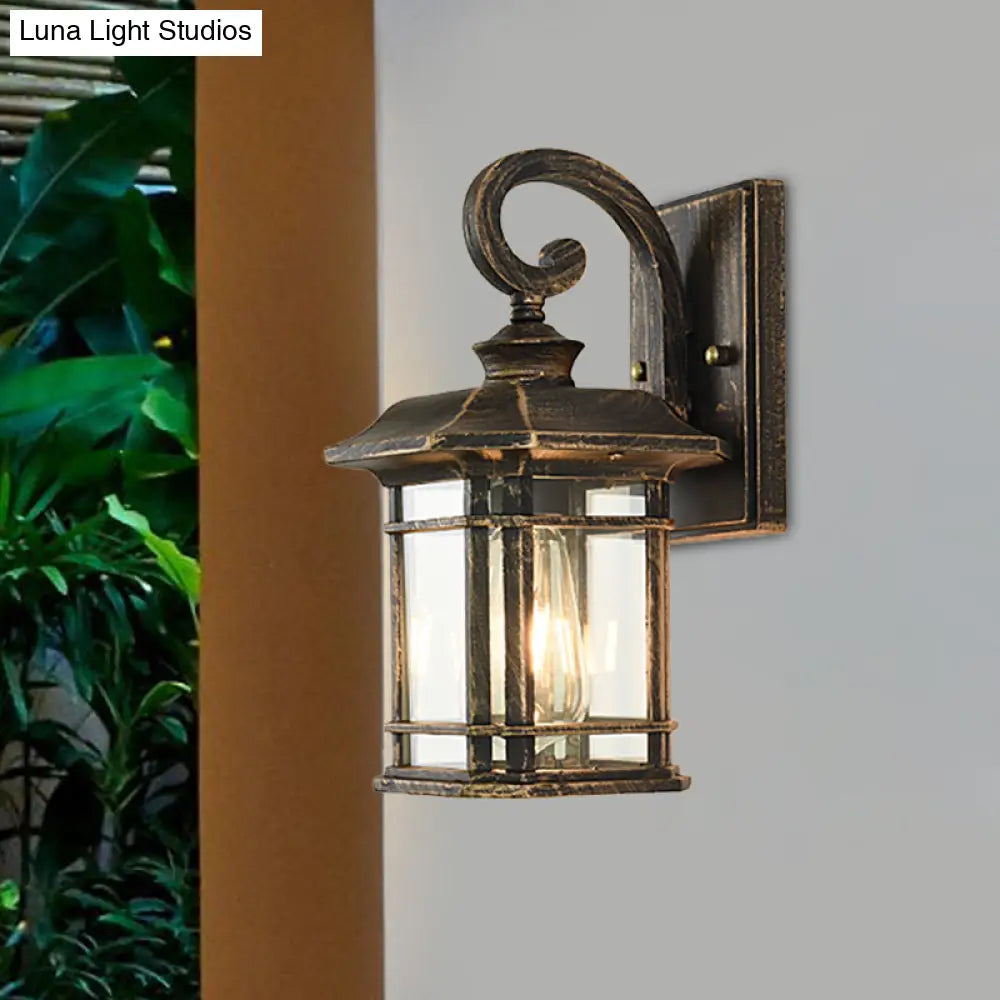 Bronze Curvy Arm Outdoor Wall Sconce With Clear Ripple Glass
