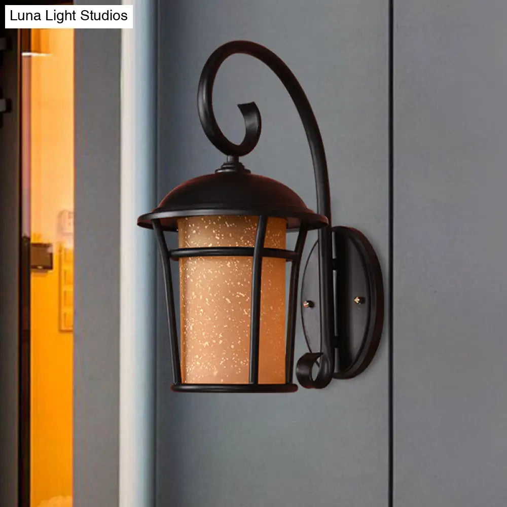 Country Black Finish Cylinder Wall Mounted Sconce With Seeded Glass And Swooping Arm