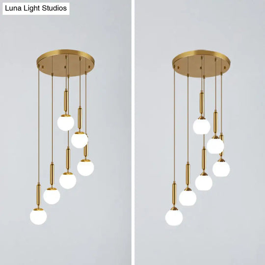 Gold Multi Hanging Stairway Light With Minimalist White Glass Ball Pendant