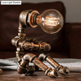 Metal Robot Table Light In Brass - Antique Finish 1 Head Nightstand Lamp For Coffee House