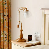 Metallic Curvy Table Lamp With Antique Style In Red Brown/Yellow Brown/Wood Finish And Clear Glass