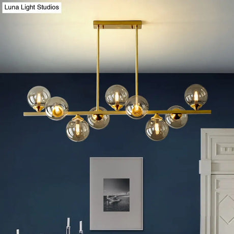 Mid-Century Modern Gold Metal Pendant With Spherical Amber Glass - Island Ceiling Light For Dining