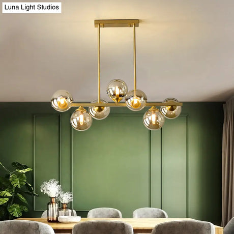 Mid-Century Modern Gold Metal Pendant With Spherical Amber Glass - Island Ceiling Light For Dining