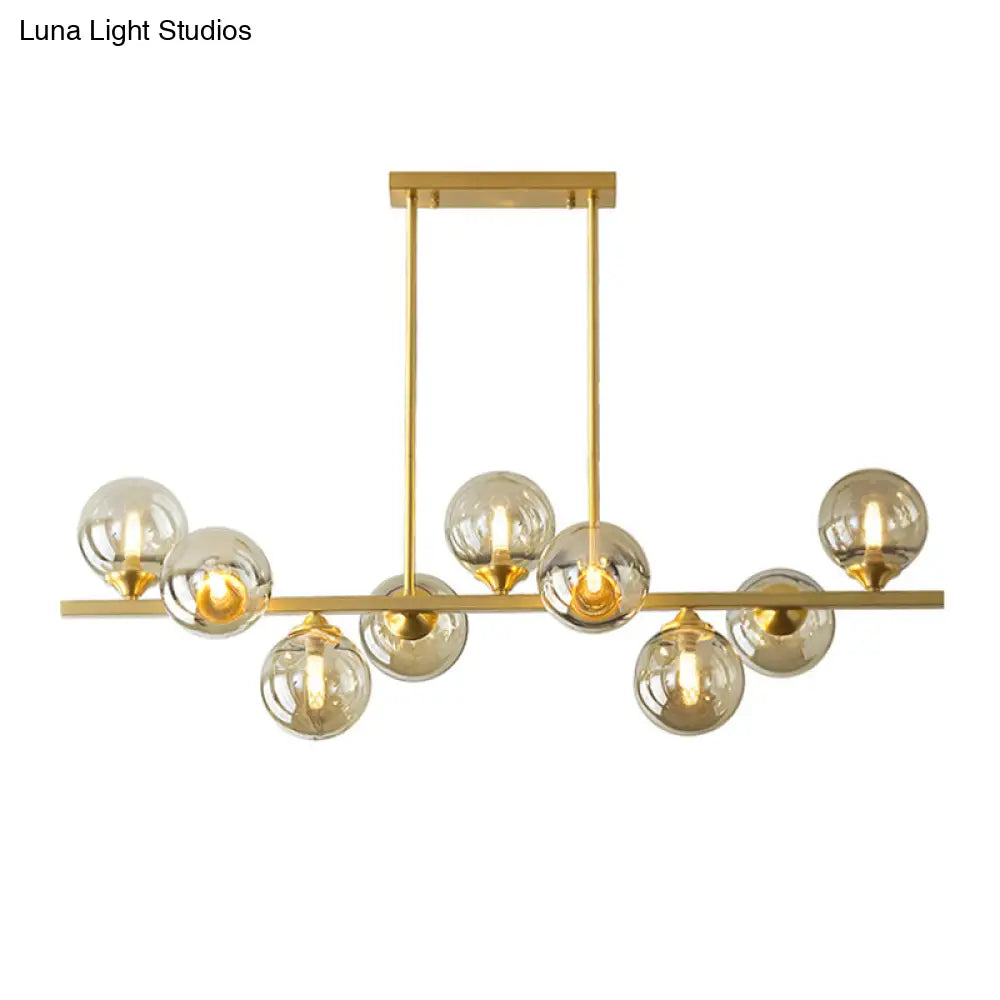 Mid-Century Modern Gold Metal Pendant With Spherical Amber Glass - Island Ceiling Light For Dining