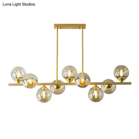 Mid-Century Modern Gold Metal Pendant With Spherical Amber Glass - Island Ceiling Light For Dining