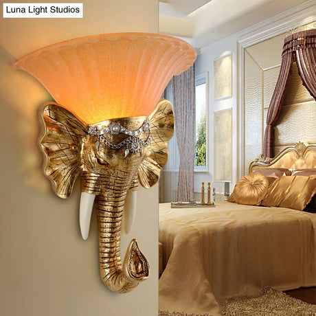Modern Amber Glass Sconce With Gold Elephant Accent