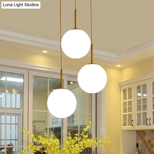 Modern White Glass Orb Hanging Ceiling Light With 3 Lights And Brass Finish