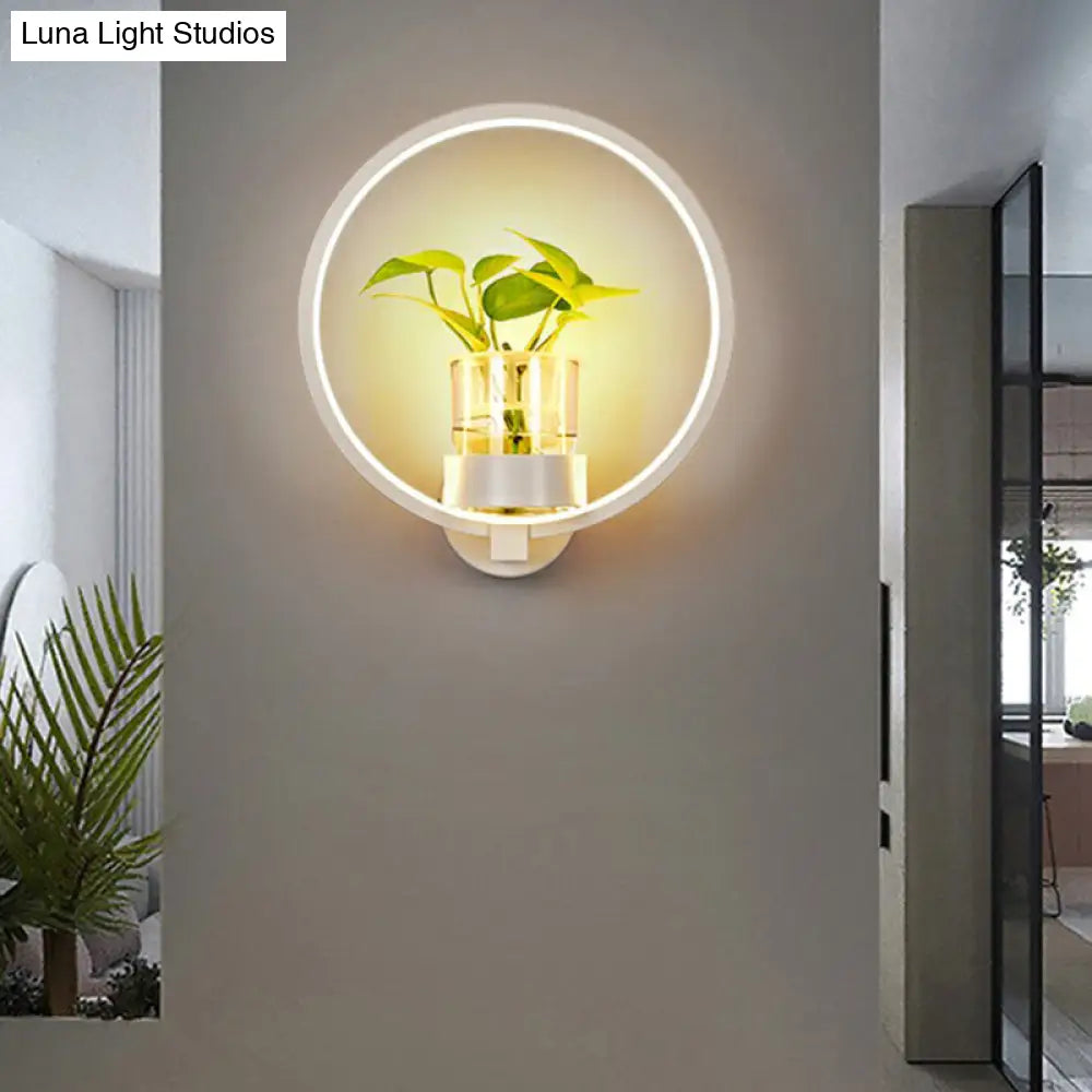 Modern Metal Wall Sconce With Artistic Loop Design And Clear Glass Plant Pot