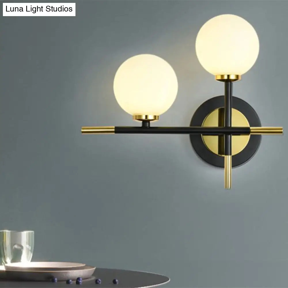 Modern Milk Glass Orb Sconce Wall Light - 2 Lights Black And Brass Cross Design