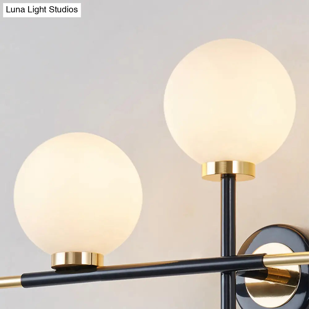 Modern Milk Glass Orb Sconce Wall Light - 2 Lights Black And Brass Cross Design