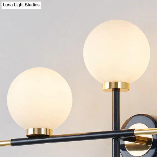 Modern Milk Glass Orb Sconce Wall Light - 2 Lights Black And Brass Cross Design