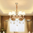 Nordic Metal Hanging Pendant Light With Scrolled Arm And Flared Glass Shade In Gold - Ideal For