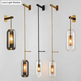 Postmodern Capsule Wall Hanging Light Clear Glass Bedside Lamp 1 Bulb Interior Mesh Guard Black/Gold