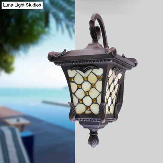 Rustic Black Wall Sconce With Scrolled Arm And Frosted Glass For Outdoor Use