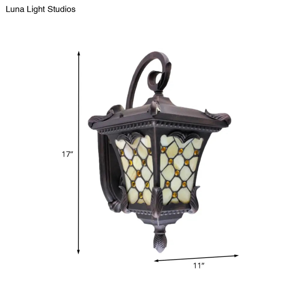 Rustic Black Wall Sconce With Scrolled Arm And Frosted Glass For Outdoor Use