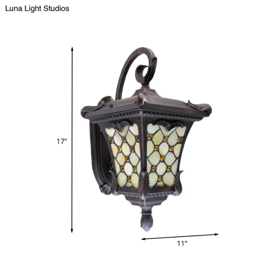 Rustic Black Wall Sconce With Scrolled Arm And Frosted Glass For Outdoor Use