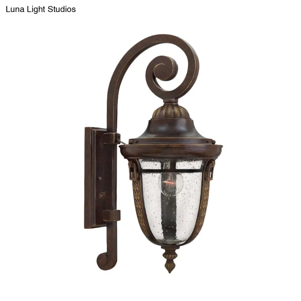 Rustic Bronze Scrolling Arm Metal Wall Lamp - 1 Light Outdoor Sconce With Seedy Glass Shade