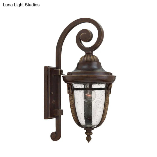 Rustic Bronze Scrolling Arm Metal Wall Lamp - 1 Light Outdoor Sconce With Seedy Glass Shade