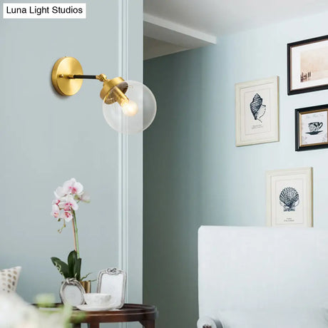 Simplicity Adjustable Globe Sconce Light Brass Wall Mount Lamp - 1 Bulb With Transparent Glass Shade