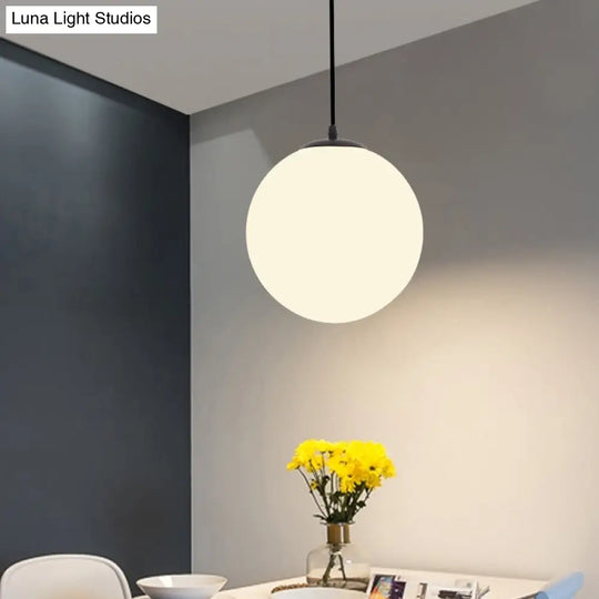 Sleek Black Sphere Restaurant Pendant Light With Cream Glass Shade - Simple Ceiling Hang Lamp