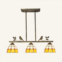 Tiffany Style Dome Shade Island Lighting - 3-Head Antique Brass/Black Hanging Lamp With Bird Accent