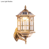 Traditional Outdoor Solar Wall Light Fixture With Metallic House Shaped Design And Clear Glass Shade