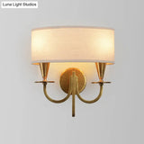 Vintage Brass Cylinder Wall Sconce With Fabric Shade And Arched Metal Arm - Ideal For Bedroom